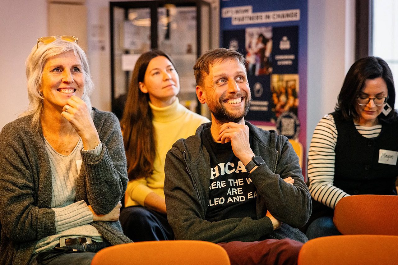 Seated people smiling