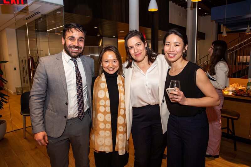 Four people smiling at event