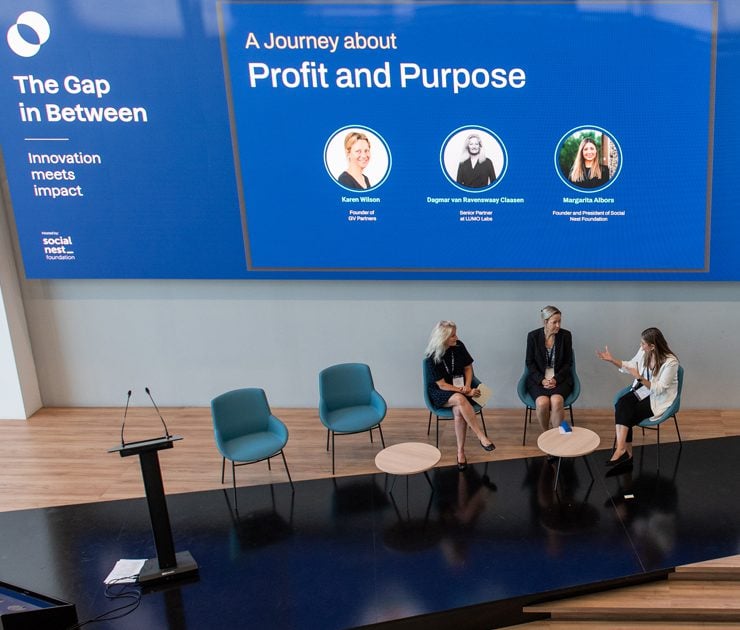 Three people on conference stage
