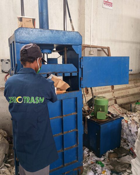 Worker at bailing machine