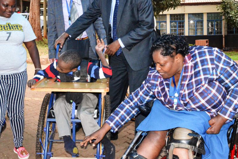 African woman in wheelchair with prosthetic leg