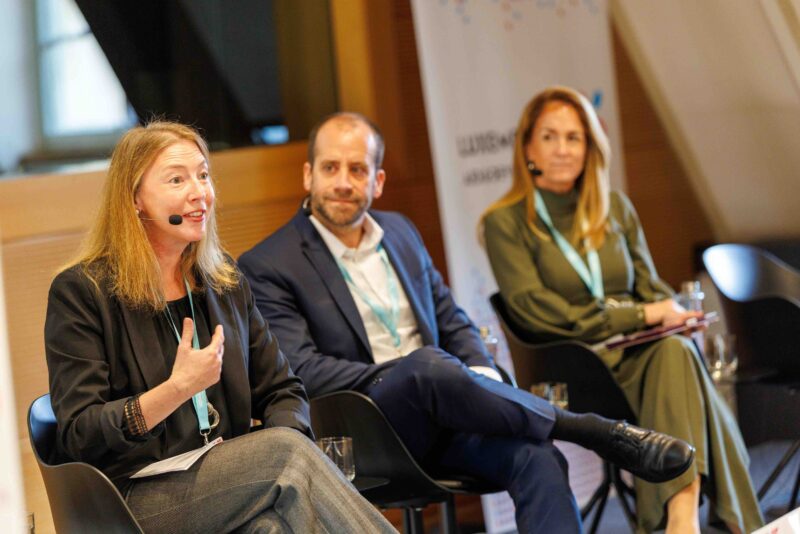 Panelists speaking at conference