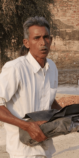Indian man holding heavy load