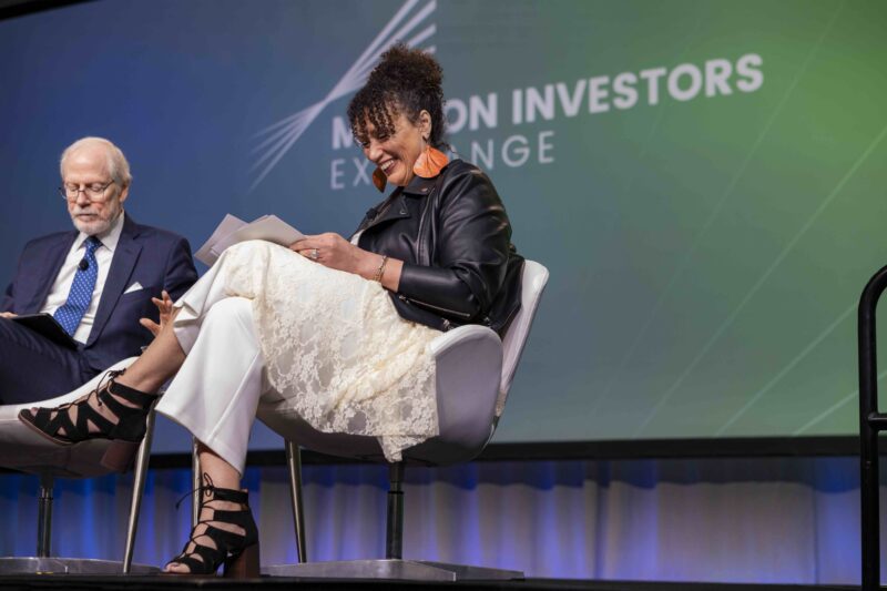 Woman and man on stage at conference