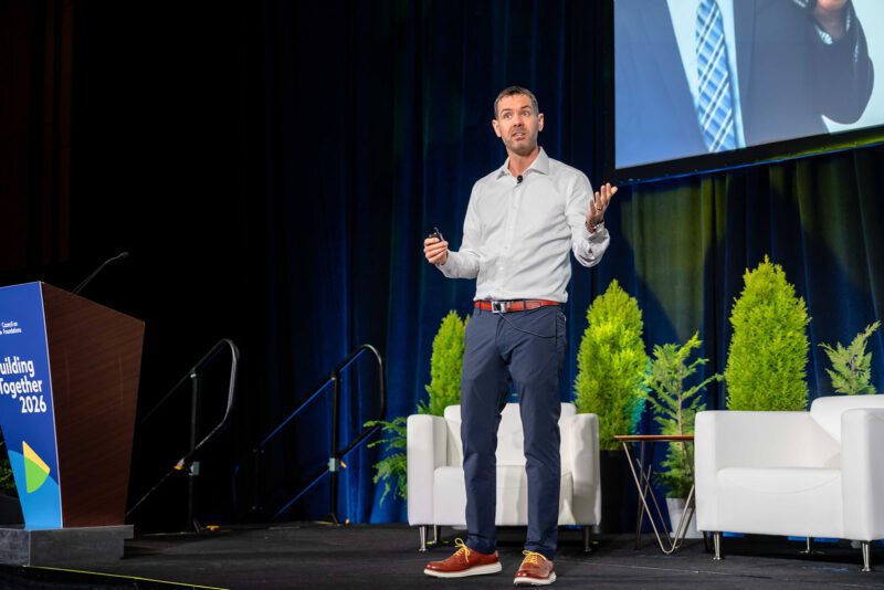Man speaking on conference stage