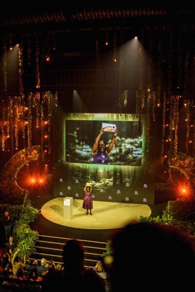 Skoll award winner on stage at ceremony
