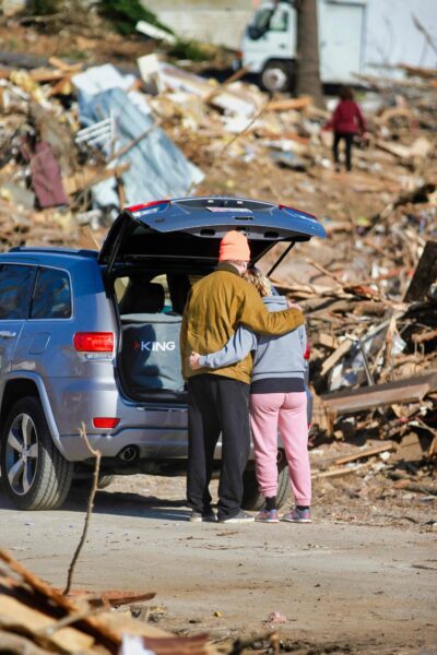 Couple in front of destroyed homes