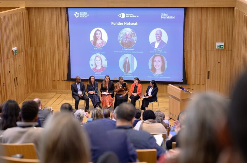 Panelists on stage at conference